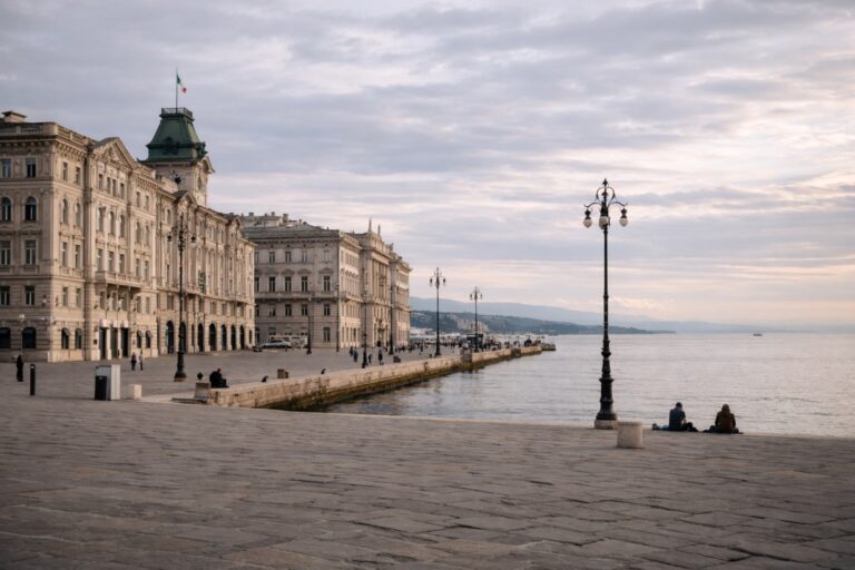 Trieste waterfront with historic buildings, open piazza, and the Adriatic Sea.