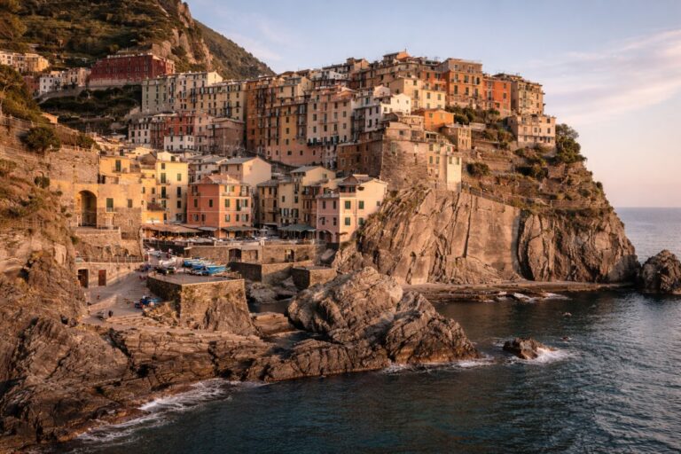 Ligurian coastal town with colorful buildings on cliffs above the sea.