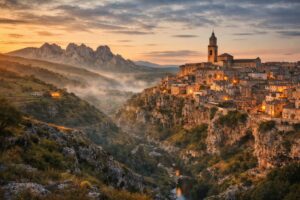 Living in Basilicata: Cliffside town above a deep valley at sunrise in Basilicata, Italy.