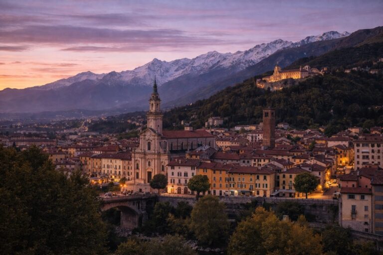 Biella cityscape at dusk with historic center and alpine foothills