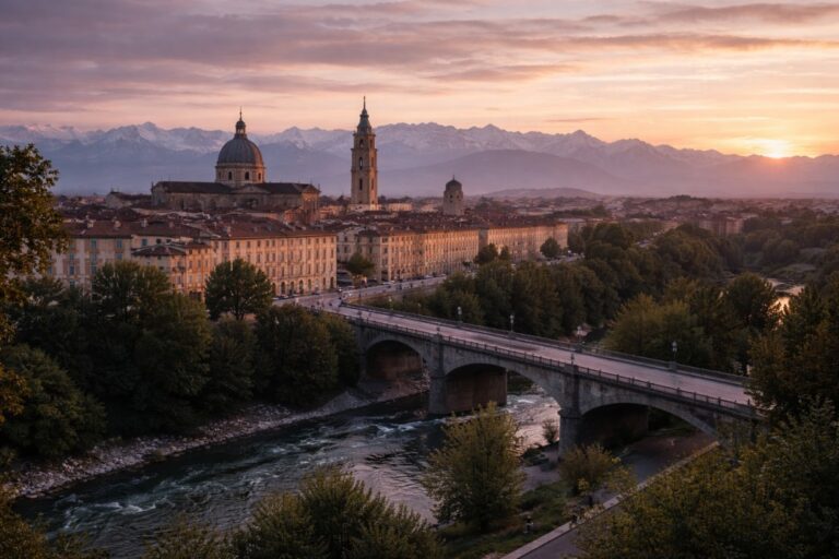Cuneo cityscape at sunset with cathedral, bridge, and the Alps