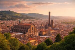 Living in Emilia Romagna skyline of Bologna under warm light, showing porticoes and dense urban fabric