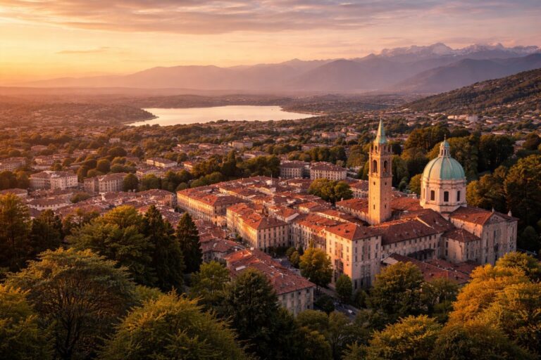 Elevated view of Varese with the historic center, surrounding hills, and Lake Varese in the background.