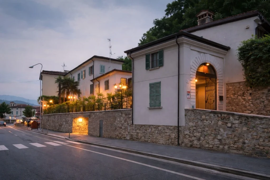 Annama coliving Brescia exterior street view with residential buildings and evening lighting