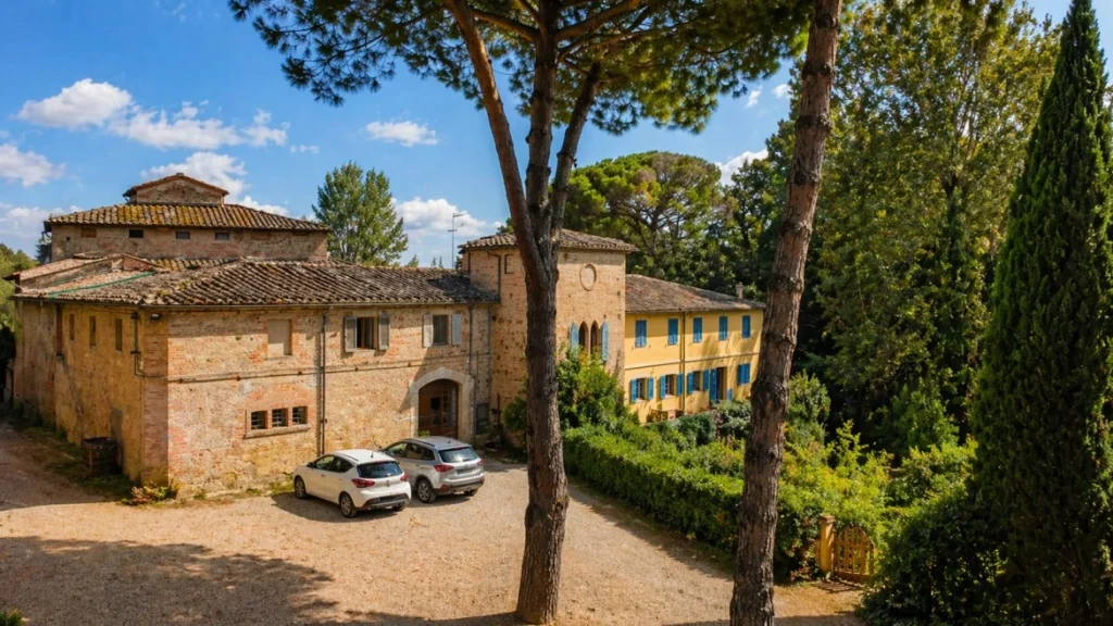 Bassetto Guesthouse Certaldo Tuscan farmhouse courtyard with cypress trees and rural setting