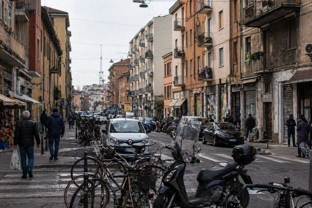 Bolognina in Bologna, Italy – mixed north-side street with shops and bikes