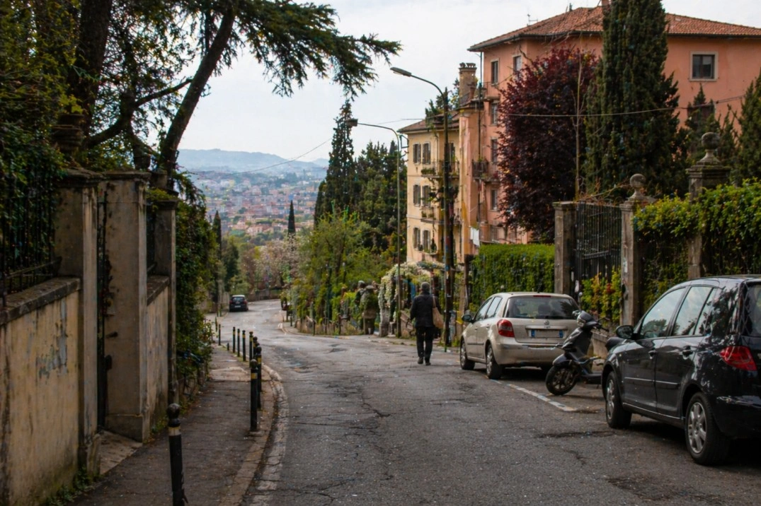 Colli in Bologna, Italy – hillside residential road with greenery and parked cars