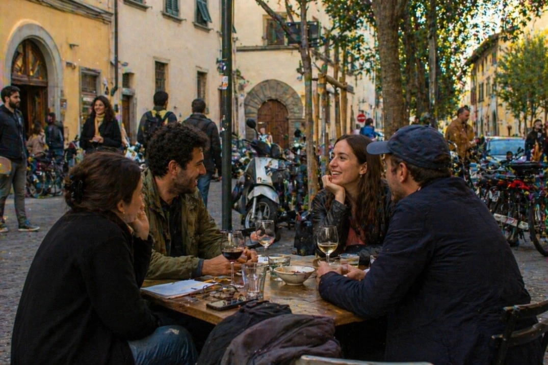 Community in Florence, Italy – small group talking at a neighborhood table