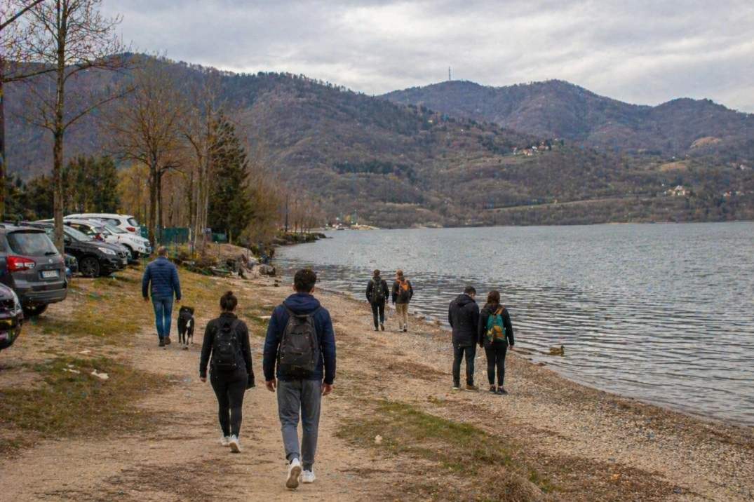 Day trips from Bologna, Italy – walkers near a lake and low Apennine hills