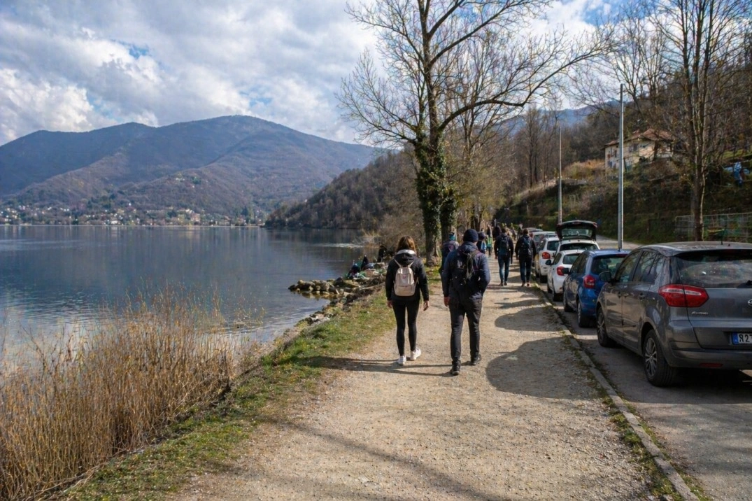 Day trips from Torino, Italy – walkers near a lake and low hills