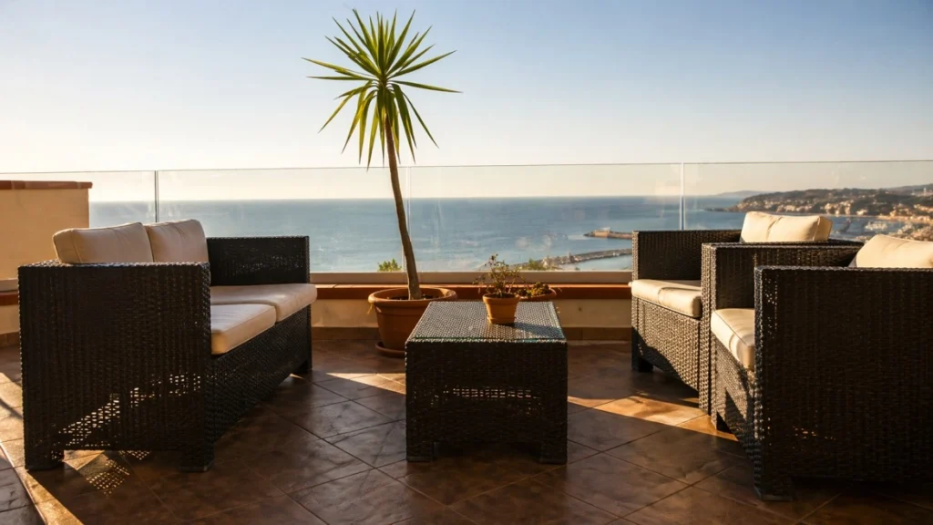 Sea view terrace at Domus Nomadi Co-Living with outdoor lounge seating and Mediterranean coastal panorama