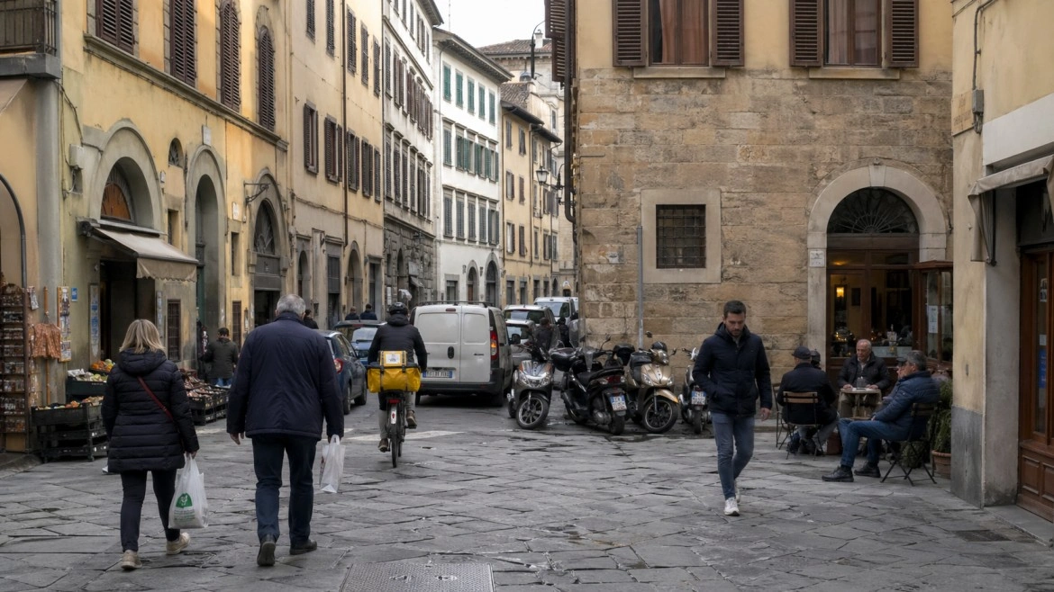 Living in Florence, Italy – pedestrians and scooters on a dense historic street