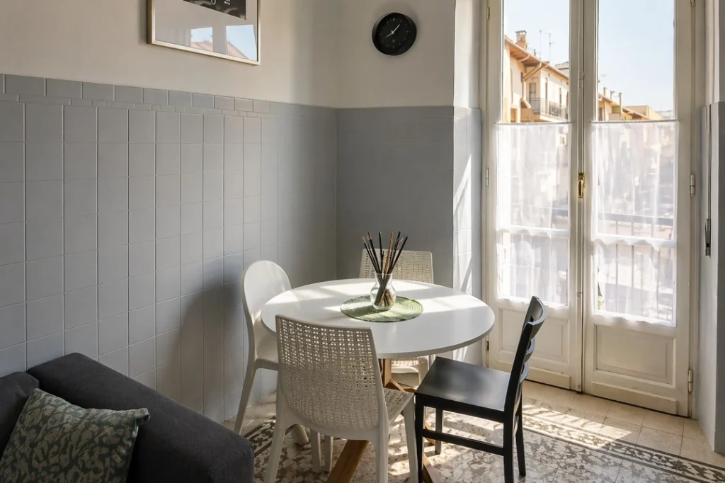 Modern shared dining area at Lomi House Galimberti in Turin with bright interiors and balcony doors