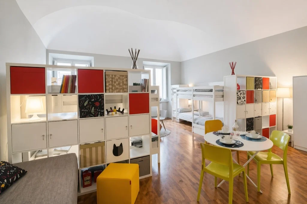 Shared loft-style coliving room at Lomi House Lorenzo with modular furniture and communal living space