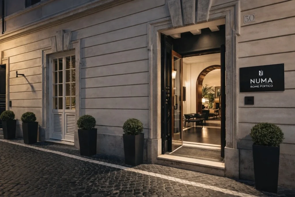 Numa Rome Portico entrance on cobblestone street with modern interior and open doorway