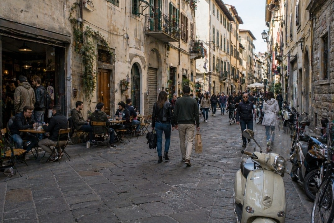 Oltrarno in Florence, Italy – artisan street with café tables and scooters