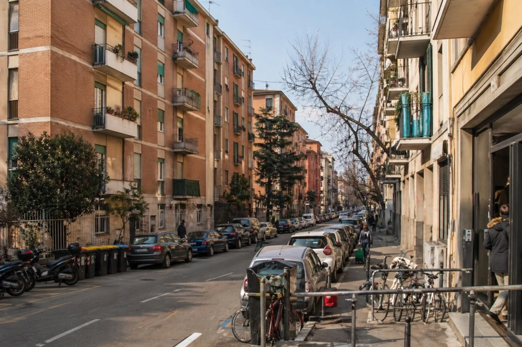 Where to live in Bologna, Italy – residential street with apartments and parked cars