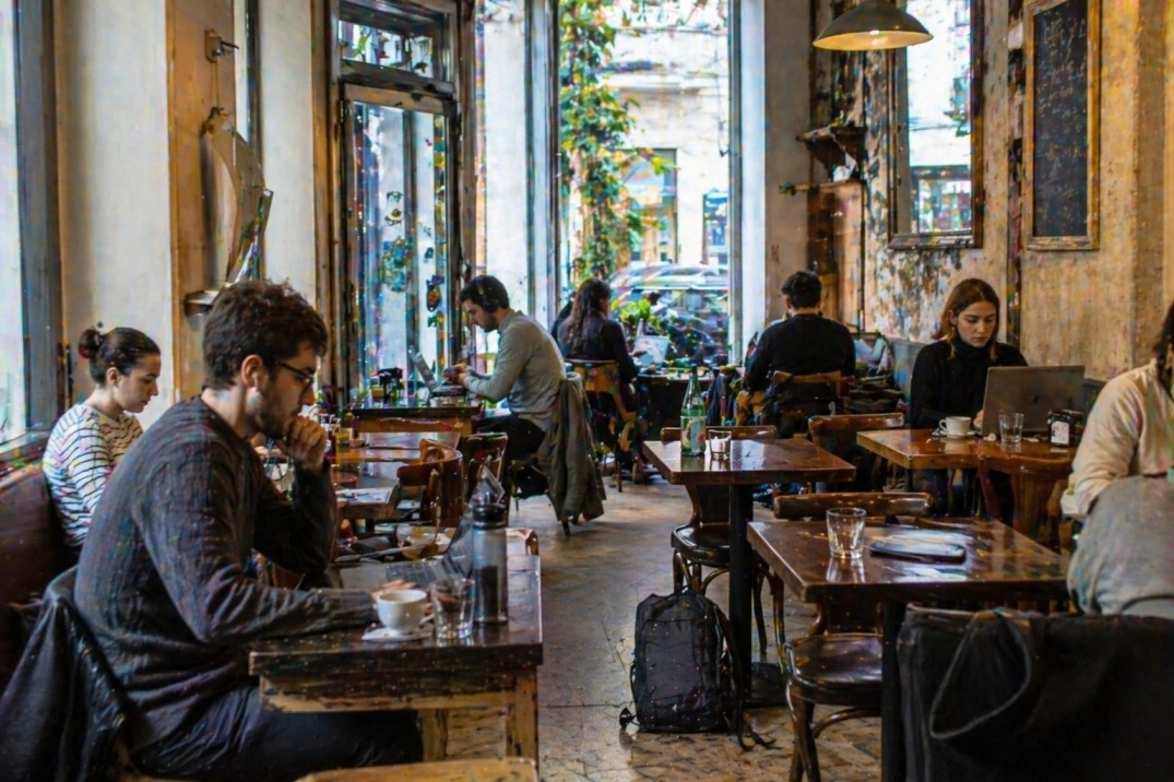 Working from Florence, Italy – laptop users in a busy café workspace