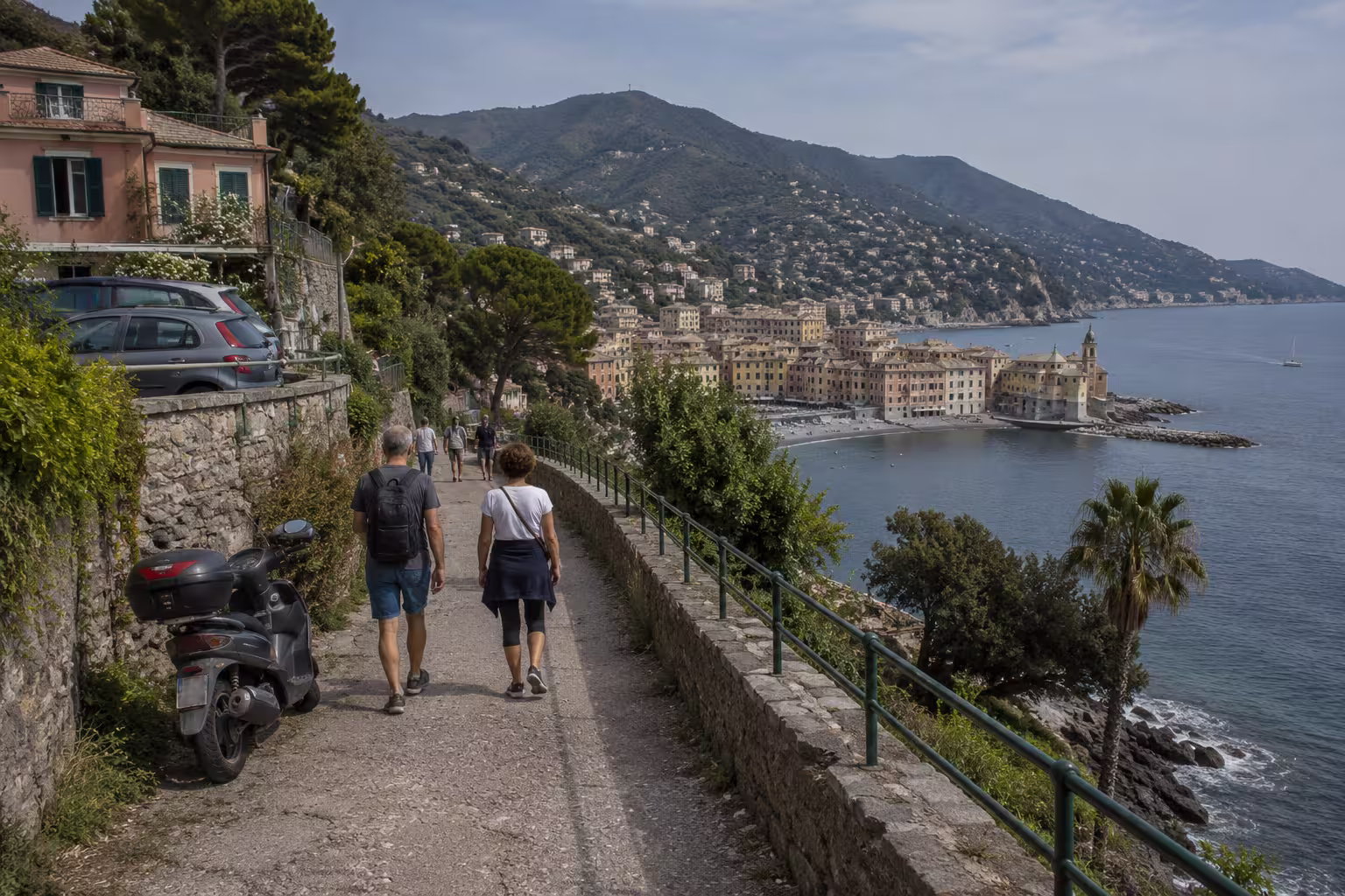 Day trips from Genova, Italy – walkers on a coastal path near hills and sea
