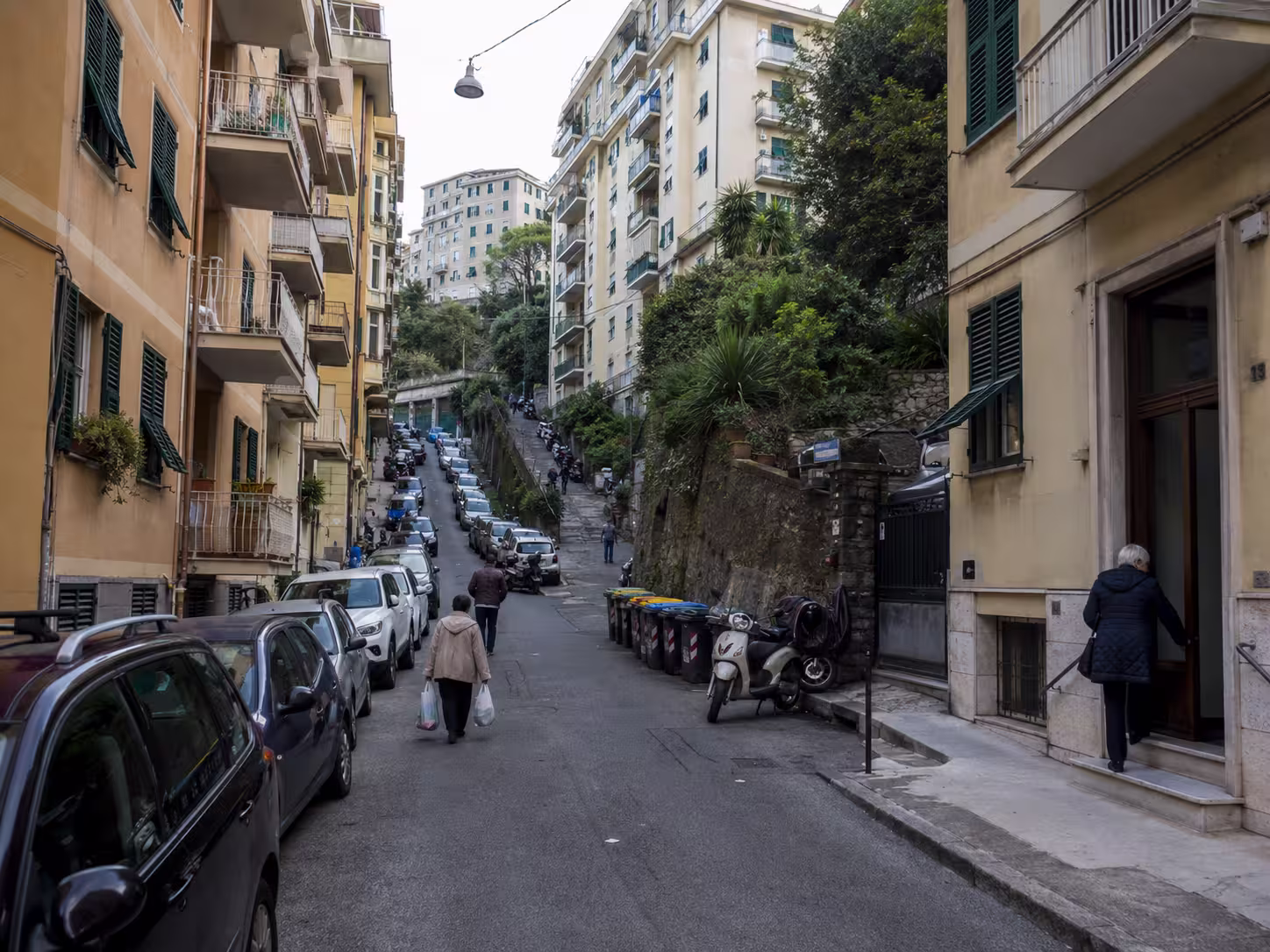 Where to live in Genova, Italy – residential street with apartments and parked scooters